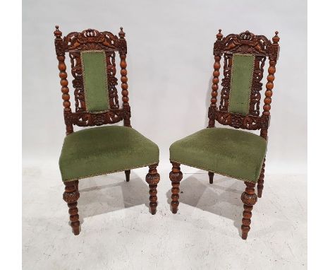 Pair of early 20th century Carolean-style chairs with carved and pierced top rails, bobbin turned back, cream upholstered sea