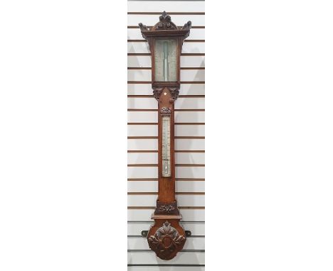 Mercury stick barometer and thermometer in ornately carved mahogany case 