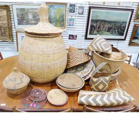 Quantity of African woven wares, to include baskets, trays and hats, some featuring zig-zag, diamond and geometric patterns.C