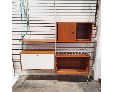 Ladderax-style wall unit with assorted teak cupboards, drawers, record spaces and fall shelf and three uprights 