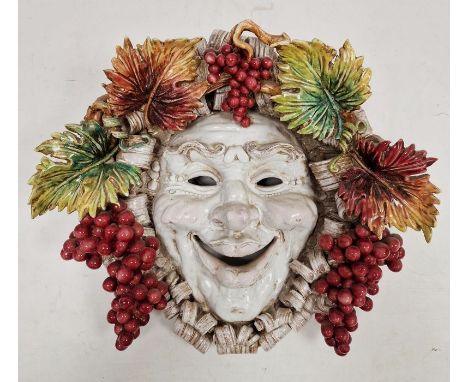 Perseo pottery Bachanalian wall mask with smiling face and fruiting vine, 42cm high x 44cm wide approx. Condition ReportNo ob