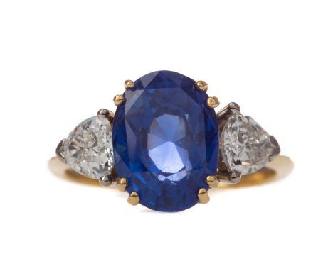 CERTIFICATED UNTREATED BURMA SAPPHIRE AND DIAMOND RING,the oval sapphire of approximately 5.79 carats flanked by trillion cut
