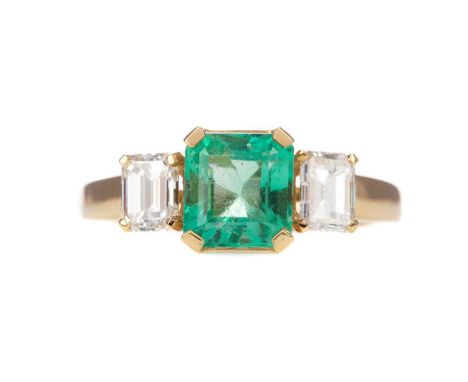 EMERALD AND DIAMOND RING,set with an octagonal step cut emerald of approximately 1.47 carats, flanked by two emerald cut diam