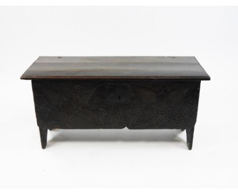 An oak six plank coffer, 17th century and later, the grooved and notched top enclosing an interior with two divisions, iron w