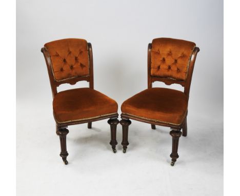 A set of six Victorian oak dining chairs, each with later upholstered button panel scroll back and over stuffed seat, raised 