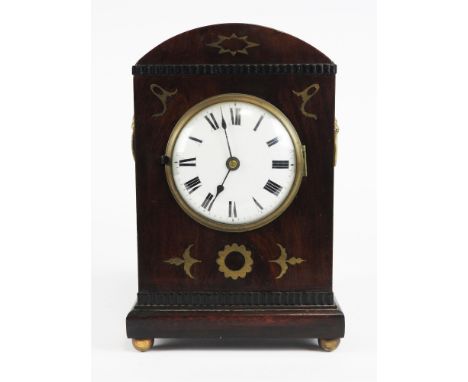 A Regency mahogany and brass inlaid dome top mantel clock with 4” white dial and Roman numerals, cornucopia cast ring handles