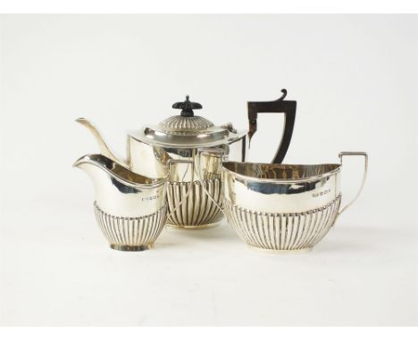 A three piece silver tea service, Jones &amp; Crompton, Birmingham 1909, each piece of oval half reeded form, comprising; a t