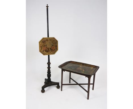An early 19 th century ebonised and gilt pole screen with canted rectangular floral tapestry panel on tripartite base and thr