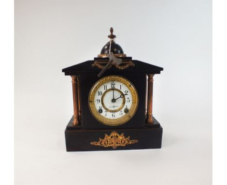 A black marble mantel clock circa 1900, of architectural form, the dial with black Arabic numerals (lacking gong), 30cm high,