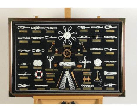 A collection of framed knots and nautical symbols with Spanish name plates, framed in a glazed presentation case, 63 x 93cm