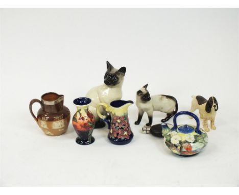 Two Beswick cats, a selection of tubelined ceramics in the Moorcroft style, a stoneware jug, a silver-plated flask and a case