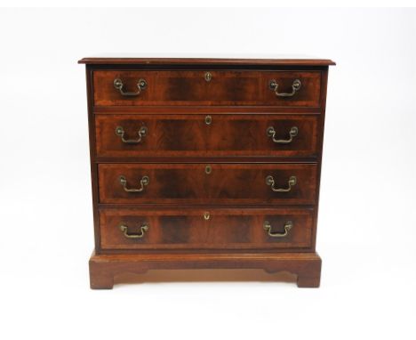 A mahogany and yewood crossbanded George III style chest of drawers, the rectangular top above four long graduated drawers on