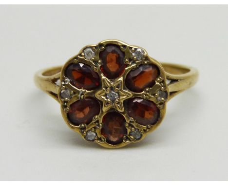 A 9ct gold garnet and diamond cluster ring, 2.8g, S 