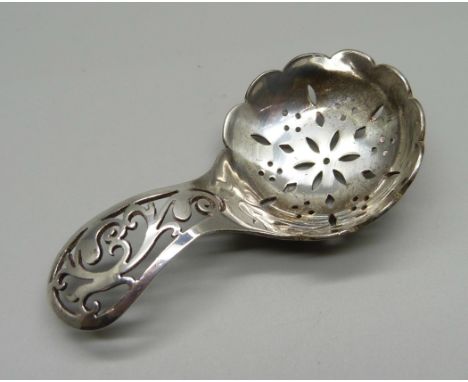A pierced silver caddy spoon, Sheffield 1938, 26g 