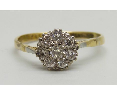 An 18ct gold and platinum set diamond cluster ring, 2.6g, T 