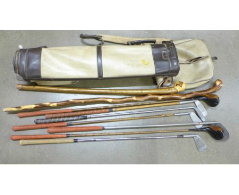 Vintage golf clubs and walking sticks in a vintage golf bag 