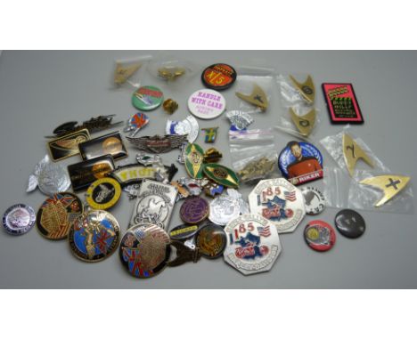 A collection of Harley-Davidson and Triumph badges and Star Trek badges 