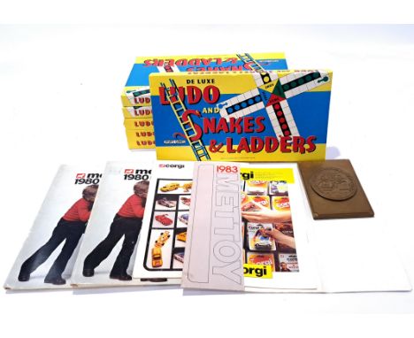 A mixed group of sorted items to include, Ludo and Snakes and Ladder board games, Corgi catalogues and similar. Not checked f