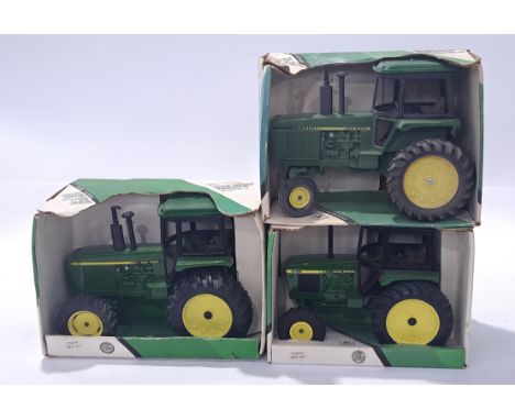ERTL, a John Deere Tractor group to include #5579, 5584 and similar. Conditions generally appear Near Mint in generally Fair 