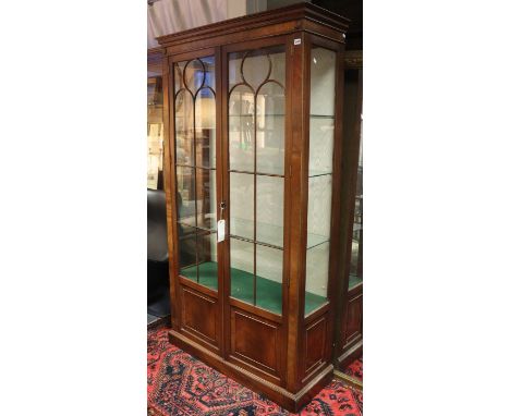 A 19th century-style mahogany tall china display cabinet fitted three plate-glass shelves enclosed by a pair of glazed &amp; 