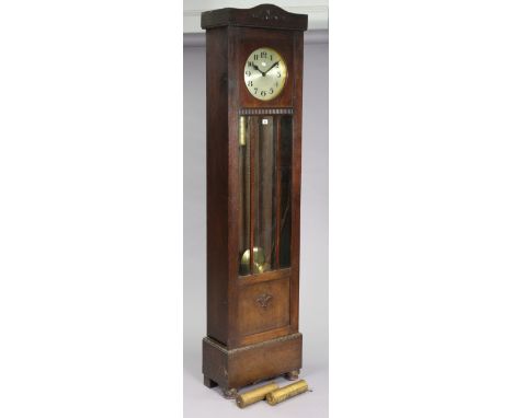 A 1950’s longcase clock with a silvered dial, chiming movement, in an oak case enclosed by a glazed &amp; panel door, &amp; o