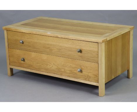 A light oak dwarf chest fitted two long drawers with knob handles, 47” wide x 21¼” high x 24½” deep. 