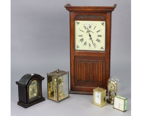 A battery-operated wall clock in a carved oak case enclosed by a glazed and linen-fold panel door, 32” high; together with fi