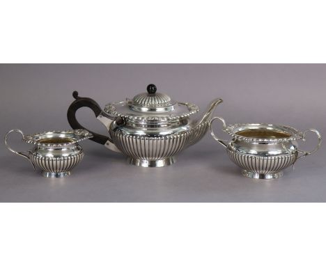 A silver-plated regency-style three-piece tea service of squat round semi-fluted form, with shell &amp; gadrooned borders.