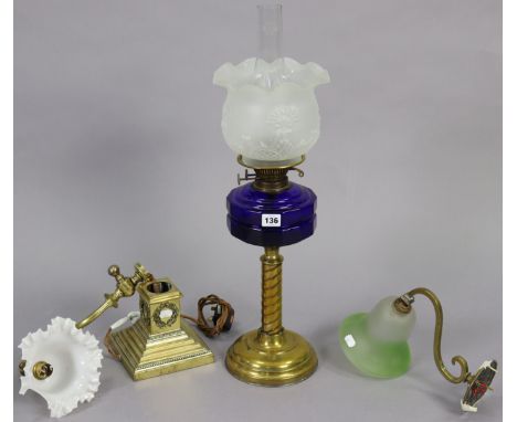 A brass oil lamp with spiral-twist column, having a blue glass reservoir, &amp; with a frosted glass shade, 26” high; togethe