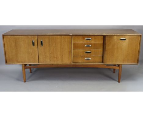 A mid-20th century G-Plan 'E.Gomme' teak sideboard fitted with an arrangement of four long drawers &amp; three cupboards each