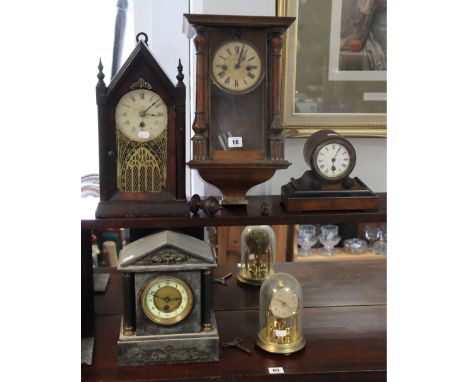 An early 20th century wall clock with black Roman numerals to the white dial, and in a walnut case enclosed by a glazed door,