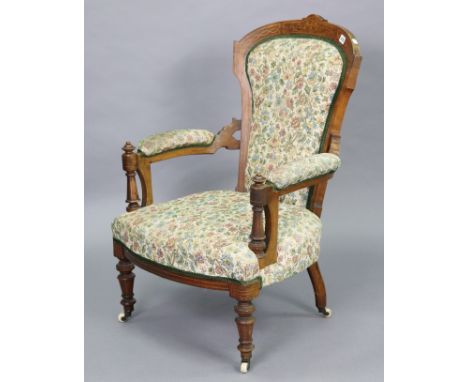 A 19th century inlaid-walnut frame armchair with a padded seat, back &amp; arms upholstered multi-coloured floral material, &