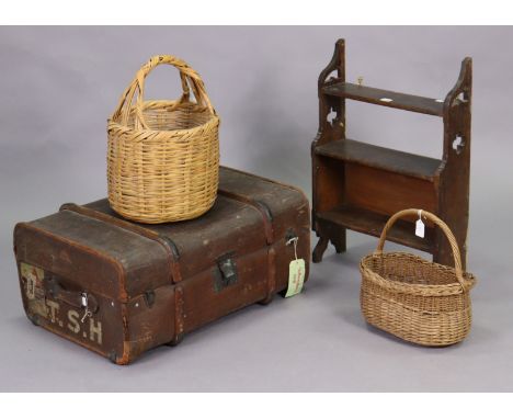 A set of Edwardian oak three-tier wall shelves, 18¾” x 27½”; together with a fibre-covered travelling trunk; &amp; two wicker