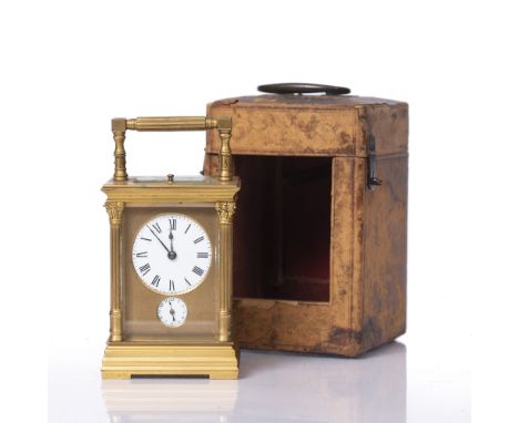 A LATE 19TH CENTURY FRENCH CARRIAGE CLOCK the masked white enamel circular Roman dial over a subsidiary alarm dial, the movem