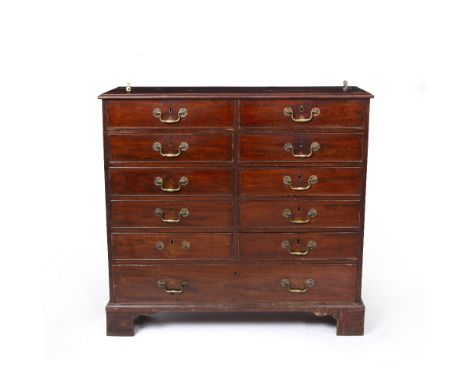 A GEORGE III MAHOGANY LIBRARY CHEST of narrow form, the moulded top above ten short and one long drawer, bracket feet, 106cm 