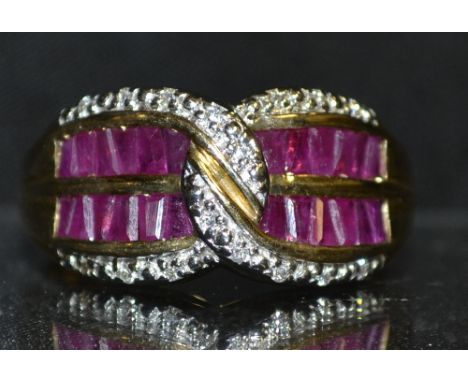 A ruby and diamond cluster ring, two rows of six irregular tapering baguette rubies, within arching intersecting rows encrust