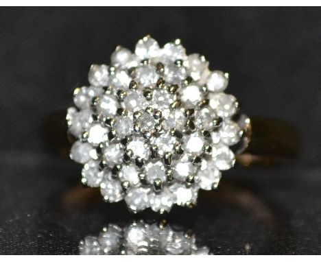 A conical diamond cluster ring, four graduating stepped crown pave encrusted with diamonds, total diamond weight approx 0.50c