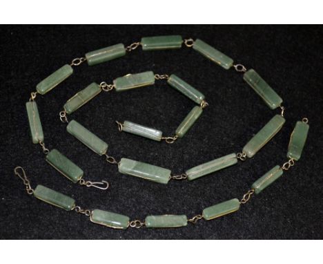 A green stone and silver necklace and bracelet suite. the necklace composed of sixteen rectangular block beads, individually 