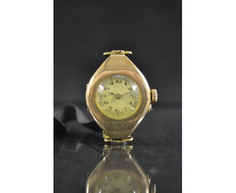 A vintage lady's 9ct gold wristwatch, oval case, round silvered dial, Arabic numerals, minute track, manual Swiss movement, 9