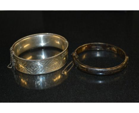 A Retro diamond cut silver hollow hinge bangle, concave body, compression clasp, safety chain, Birmingham 1963;  another smal
