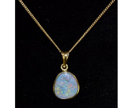 An opal doublet pendant necklace, free form rounded triangular pendant, flashing purple, blue, orange and green colour play, 