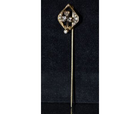 An Art Nouveau diamond and seed pearl stick pin, open arched square crest encrusted with a central round cut diamond and twen