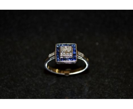 A diamond and blue sapphire Art Deco cluster ring, central prince cut diamond surrounded by sixteen square cut blue sapphires