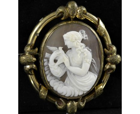 A 19th century Victorian shell cameo brooch, central revolving oval shell panel carved with seated Psyche holding a dove, gla