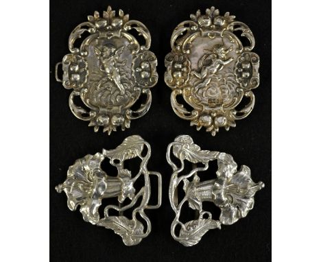 A Victorian silver hinged cherub two section belt buckle, repousse decorated with winged cherubs amongst clouds, engraved ver