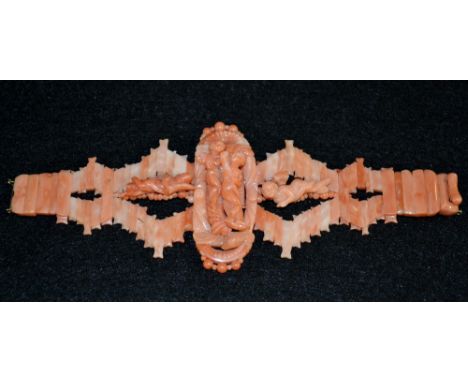 A 19th century Italian carved coral panel bracelet, multi-layer central oval panel, carved in relief with a Nymph and Cherub 