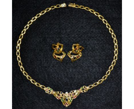 A diamond, emerald, ruby and sapphire mounted 18ct yellow gold necklace and earring three piece suite, central fixed panel in