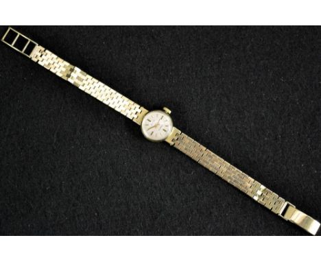 An Accurist lady's 9ct gold cased wrist watch, silvered dial, baton markers, 21 jewel manual movement, stamped F K, integral 