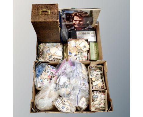 Two boxes containing a large quantity of loose stamps, an album of first day covers, magnifiers, an index drawer together wit