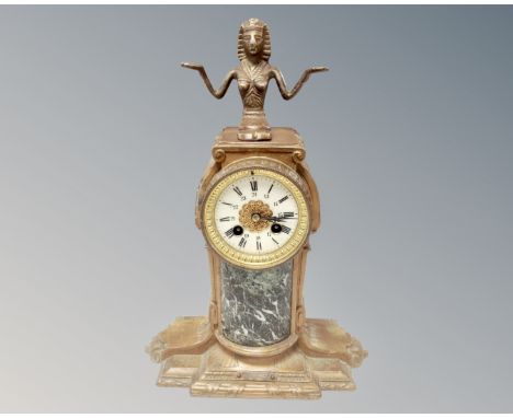 A 19th century painted metal and marble 24 hour mantel clock surmounted by an Egyptian figure 